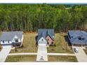 An aerial view of a house showcasing its landscaping and neighborhood surroundings at 230 Sutherland Dr, Franklinton, NC 27525