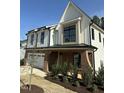 Two-story home with brick and white facade, manicured shrubs, and trimmed grass at 240 Sutherland Dr, Franklinton, NC 27525