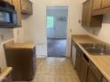 Galley kitchen with a wood cabinets and an eat-in area near the back door at 2408 Stadium Dr # A, Durham, NC 27704