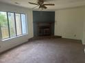 Cozy living room featuring a brick fireplace and large window for natural light at 2408 Stadium Dr # A, Durham, NC 27704