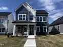 Beautiful two-story home showcasing blue and white siding, a brick accent, and a welcoming walkway at 269 Marvel Dr # 138, Rolesville, NC 27571