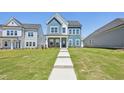Attractive two-story home with a green lawn and inviting walkway to the covered front porch at 269 Marvel Dr # 138, Rolesville, NC 27571