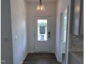 Bright foyer with wood-look flooring, white walls, and a stylish light fixture at 269 Marvel Dr # 138, Rolesville, NC 27571