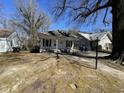 Cottage-style home's front yard and driveway with neighboring homes and mature landscaping at 2711 Ashe St, Durham, NC 27703