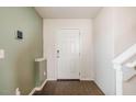 Entryway with wood flooring and coat closet, featuring a staircase and direct access to the main living areas at 314 Mason Trace, Burlington, NC 27217