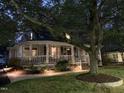 Charming traditional home with welcoming front porch, enhanced by landscape lighting at 321 W Chatham St, Cary, NC 27511