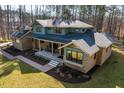 Lovely brick two-story home offers a covered front porch and a meticulously maintained front lawn and landscaping at 38 Kingbird Ln, Chapel Hill, NC 27517