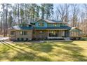 Charming brick two-story home features a covered front porch and a well-manicured lawn and landscaping at 38 Kingbird Ln, Chapel Hill, NC 27517