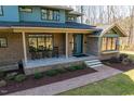 Inviting front porch with brick flooring and rocking chairs; perfect for relaxing and enjoying the outdoors at 38 Kingbird Ln, Chapel Hill, NC 27517