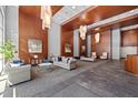 Spacious lobby area with cozy seating, contemporary lighting fixtures, and elegant wood paneling at 400 W North St # 804, Raleigh, NC 27603