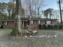 Charming brick home featuring a well-maintained front yard, beautiful landscaping and mature trees at 431 S Harrison Ave, Cary, NC 27511