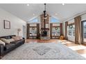 Bright living room boasting high vaulted ceilings, a brick fireplace, and large windows at 4420 Bunton Swaim Rd, Liberty, NC 27298