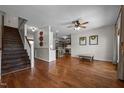 Open-concept living space with hardwood floors, shiplap accent wall, and staircase at 4420 Bunton Swaim Rd, Liberty, NC 27298