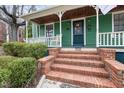 Inviting front porch with brick steps, a charming green door, and stylish details at 603 Polk St, Raleigh, NC 27604