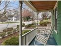 Cozy front porch featuring rocking chairs, a view of the street, and classic details at 603 Polk St, Raleigh, NC 27604
