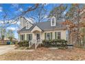 Delightful single-Gathering home with green shutters, dormers, and a walkway to the front door at 6100 River Laurel Ct, Raleigh, NC 27604