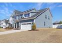 A two-story home with light blue siding, white accents, a driveway, and a two-car garage at 624 Red Arrow Dr, Knightdale, NC 27545