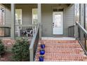 Close-up of inviting front porch with brick steps and decorative planters at 727A Peyton Ave, Durham, NC 27703