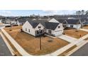 An aerial view showcasing the side of the property and its well-maintained lawn in a suburban setting at 82 Coble Farms Pl, Fuquay Varina, NC 27526