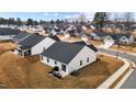 An aerial view of the back of the home featuring a patio, grill, and surrounding neighborhood at 82 Coble Farms Pl, Fuquay Varina, NC 27526