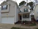 Beautiful two-story home with a one car garage, a cozy front porch and well-maintained landscaping at 821 Brookhannah Ct, Fuquay Varina, NC 27526