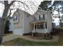Charming two-story home with one car garage, front porch and mature trees in a well-maintained yard at 821 Brookhannah Ct, Fuquay Varina, NC 27526