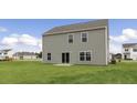 Rear view of the home showing the siding and large backyard at 871 Forth Ct, Gibsonville, NC 27249