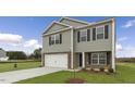 Charming two-story home featuring a stone facade, attached garage, and a spacious lawn at 871 Forth Ct, Gibsonville, NC 27249