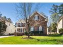 Lovely two-story brick home boasts beautiful landscaping and a classic architectural design at 9344 Palm Bay Cir, Raleigh, NC 27617