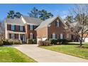 Beautiful brick home with a well-maintained lawn and driveway, showcasing curb appeal at 9344 Palm Bay Cir, Raleigh, NC 27617