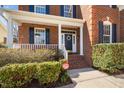 Close-up of the front porch of a brick home, showcasing the welcoming entrance at 9344 Palm Bay Cir, Raleigh, NC 27617