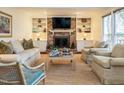 Comfortable living room featuring a brick fireplace, built-in shelves and neutral furniture at 10005 Avocado Cir, Raleigh, NC 27615