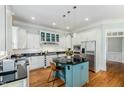 Modern kitchen boasts stainless steel appliances, an island, and a sleek design at 101 N Bloodworth St, Raleigh, NC 27601