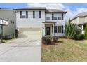 Inviting two-story home features light siding, black shutters, a front-entry garage, and a basketball hoop on the driveway at 1033 Leatherstone Ln, Fuquay Varina, NC 27526