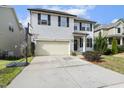 Charming two-story home with light siding, a spacious driveway, and a basketball hoop for Gathering fun at 1033 Leatherstone Ln, Fuquay Varina, NC 27526