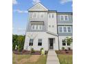 Charming two-story home with light gray and white exterior paint and landscaping at 1035 Zelkova Ln, Chapel Hill, NC 27517
