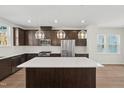 Modern kitchen featuring stainless steel appliances, granite countertops, and stylish pendant lighting at 1035 Zelkova Ln, Chapel Hill, NC 27517