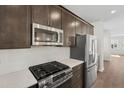 Close up of the kitchen with stainless steel appliances and granite counter tops at 1035 Zelkova Ln, Chapel Hill, NC 27517