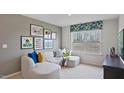 Cozy living room with comfortable sectional sofa, gallery wall, and bright natural light at 106 Craig Point Dr, Clayton, NC 27520
