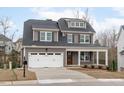 Charming two-story home featuring a gray exterior, white trim, covered porch, and a two-car garage at 116 Pointe Park Cir, Holly Springs, NC 27540