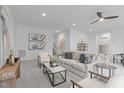 Inviting living room boasts soft carpeting, a contemporary ceiling fan, and stylish furniture for a cozy feel at 116 Pointe Park Cir, Holly Springs, NC 27540