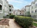 Exterior view of buildings with professional landscaping and black iron fence at 1210 Westview Ln # 201, Raleigh, NC 27605