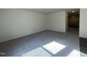 The living room is spacious with modern gray flooring and lots of natural light at 128 Oat Grain Ct, Clayton, NC 27520