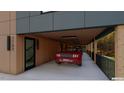 Well-lit garage featuring sleek concrete floors, wood ceiling, a red car, and an open design at 1709 Evergreen Ave, Raleigh, NC 27603