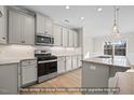 Well-equipped kitchen featuring granite countertops, stainless steel appliances, and ample cabinet space at 1811 Parham Dr, Graham, NC 27253