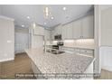 Spacious kitchen with a large island, granite countertops, stainless steel appliances, and pendant lighting at 1811 Parham Dr, Graham, NC 27253