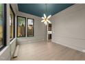 Elegant dining room with hardwood floors, a statement chandelier, and large windows, perfect for entertaining at 2305 Turners Aly, Raleigh, NC 27607