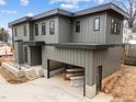 Side view of a contemporary gray home with an open garage and unfinished landscaping at 2305 Turners Aly, Raleigh, NC 27607