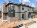 Contemporary home with a combination of brick and siding, black-framed windows, and a modern roofline at 2305 Turners Aly, Raleigh, NC 27607