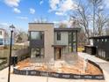 Contemporary-style home with a brick and siding exterior, complemented by black-framed windows at 2305 Turners Aly, Raleigh, NC 27607